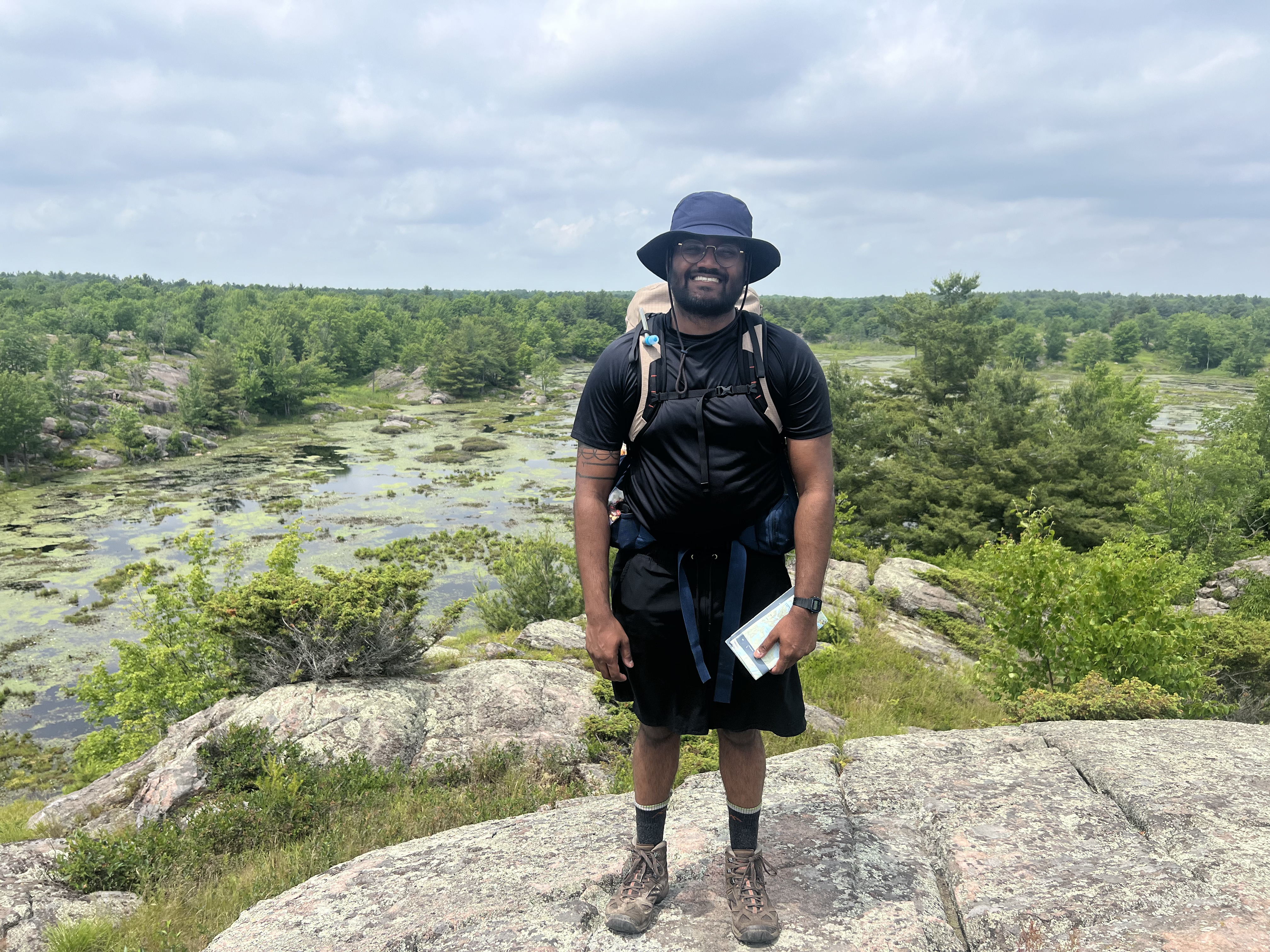 A guy standing at the top of a hill