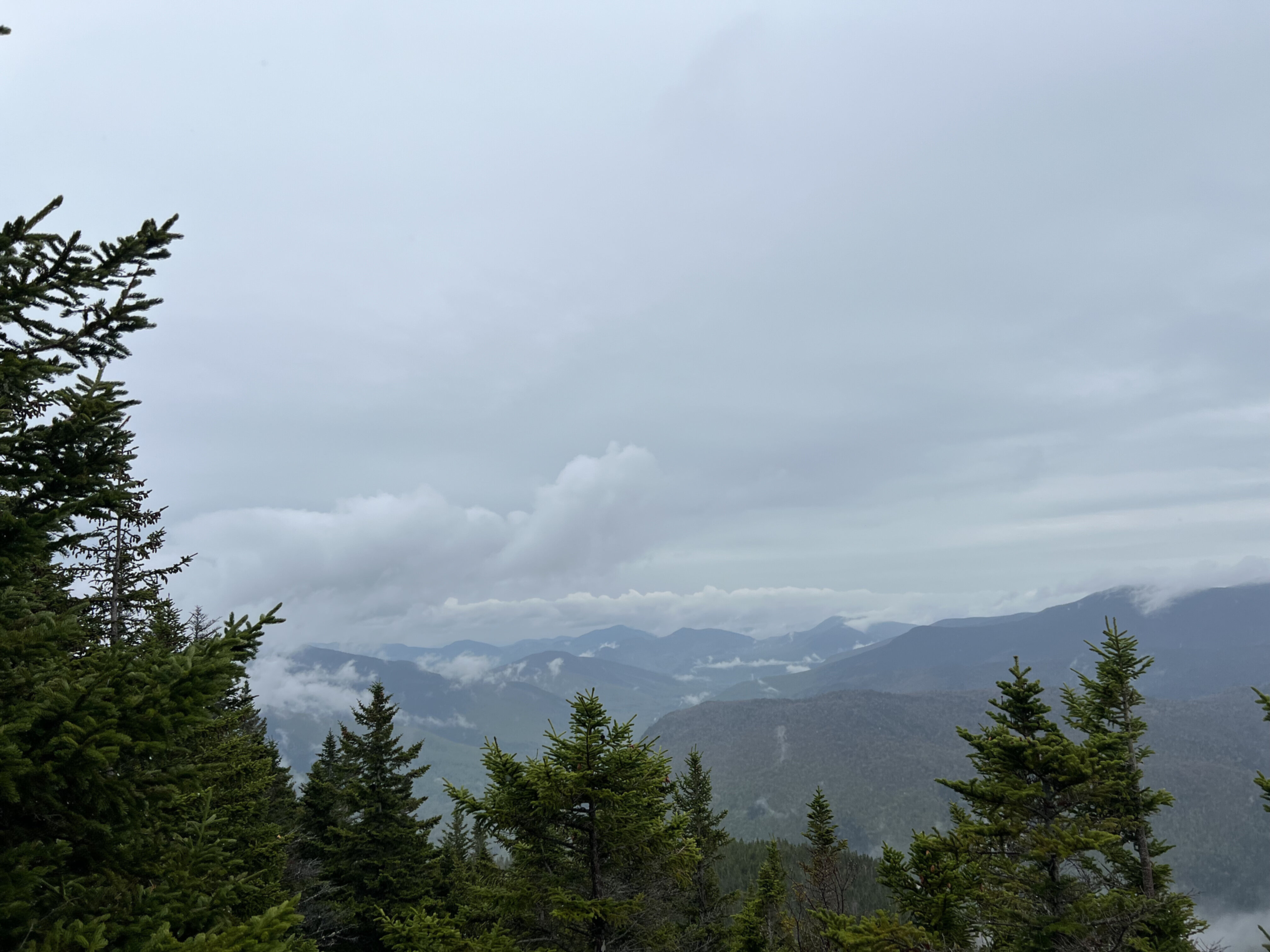 A foggy and cloudy picture of mountains