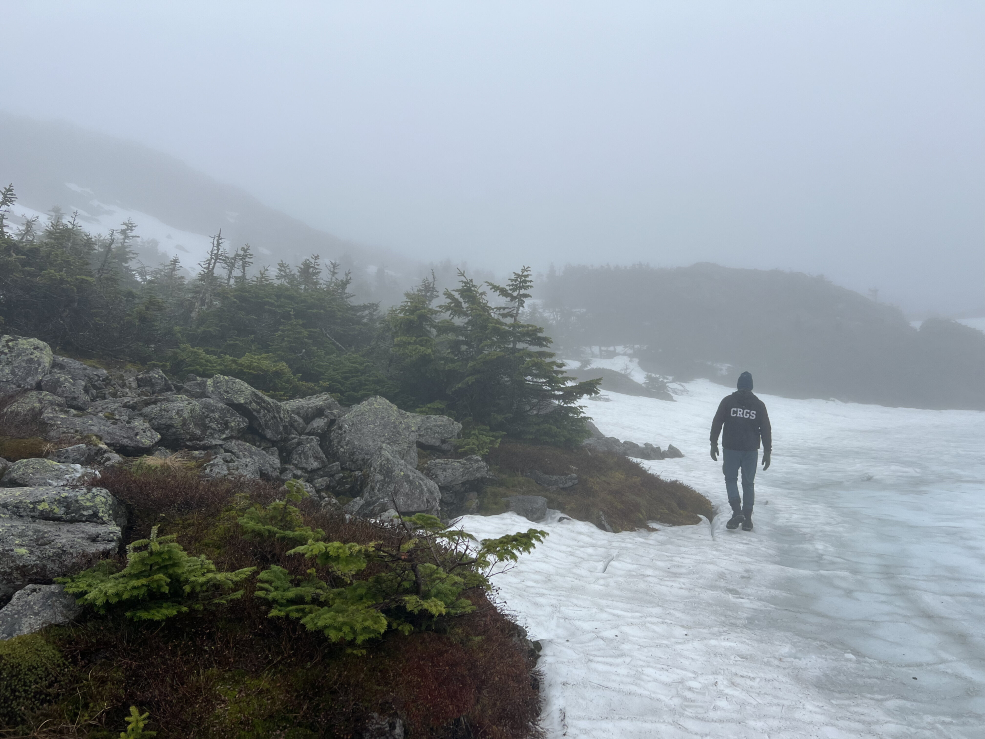 A man walking along an ice lake