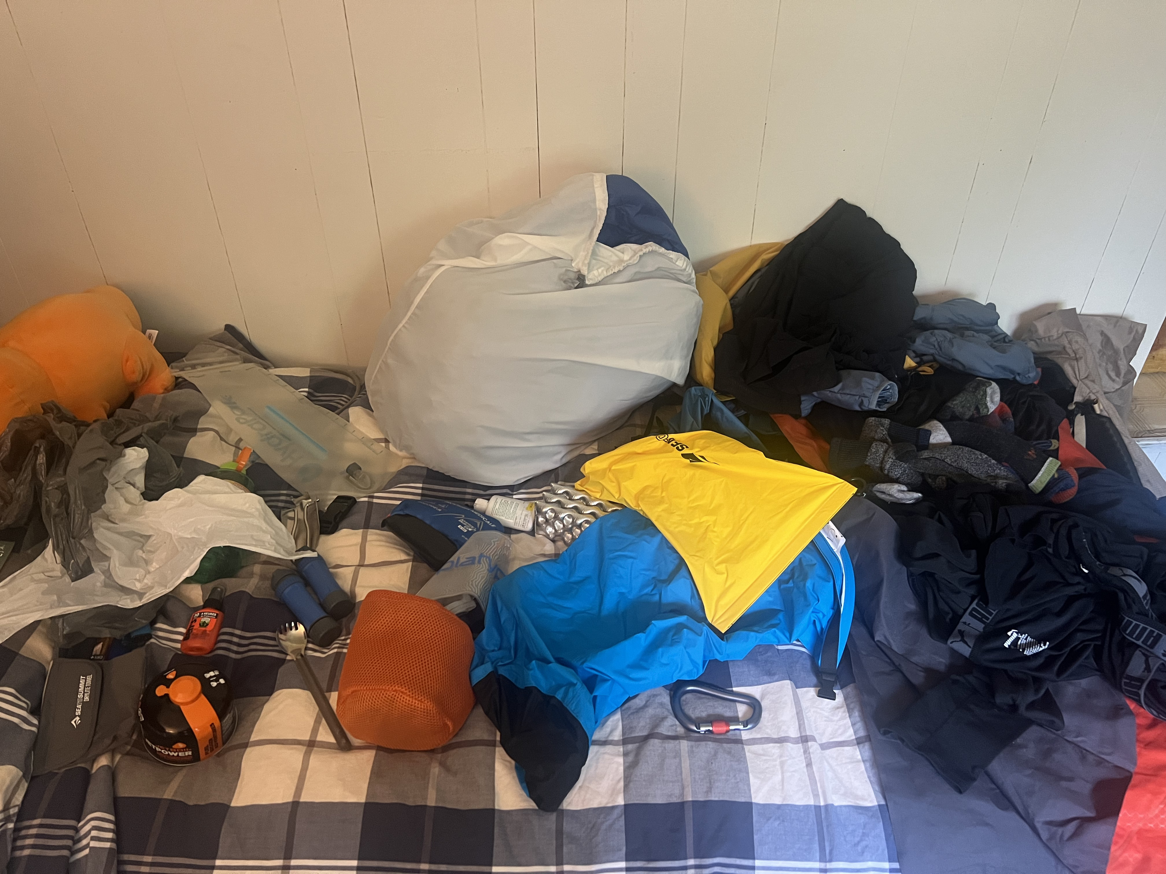 Camping gear placed on bed