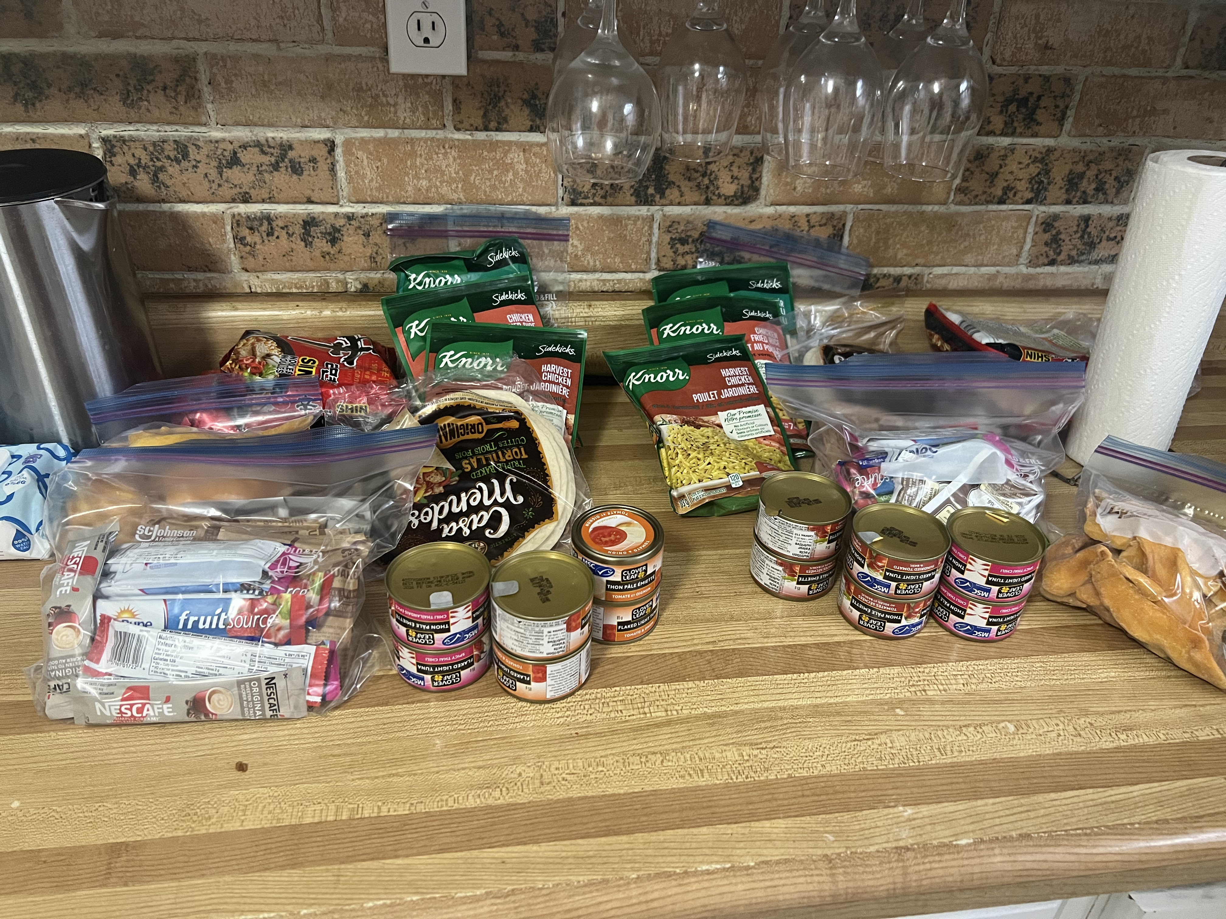 tortillas, cans and other food on a kitchen counter